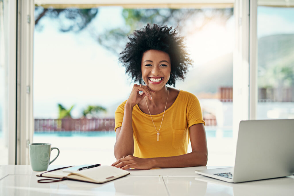 Cropped portrait of an attractive young woman working on her laptop at home